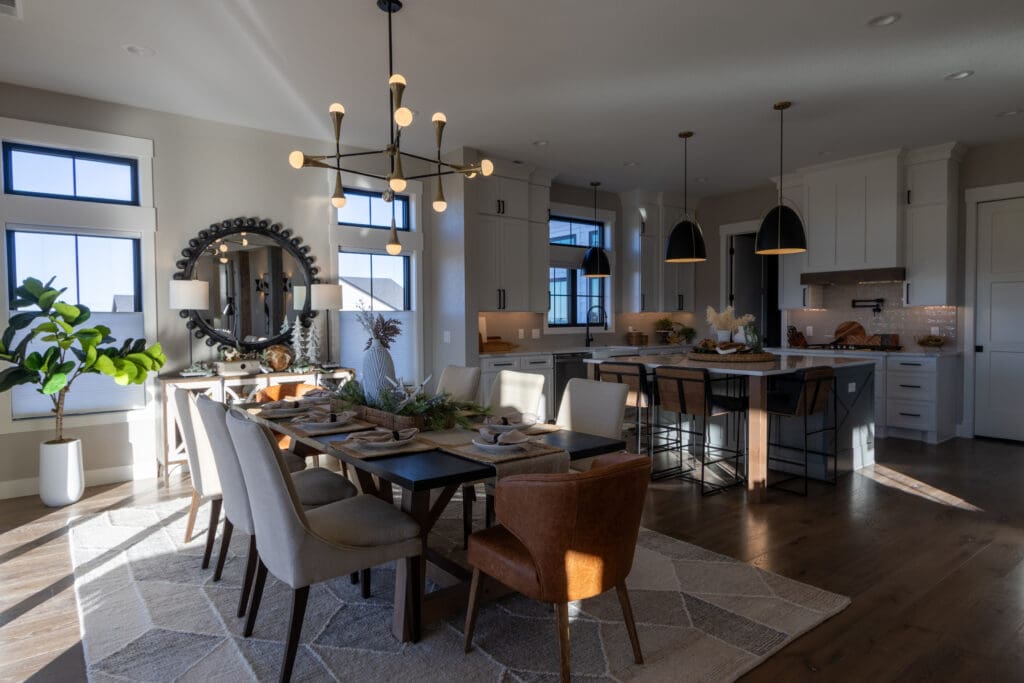 Open dining room and kitchen with Agreeable Gray walls, Extra White ceilings, and white trim in a new Spearfish, SD home