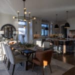 Open dining room and kitchen with Agreeable Gray walls, Extra White ceilings, and white trim in a new Spearfish, SD home