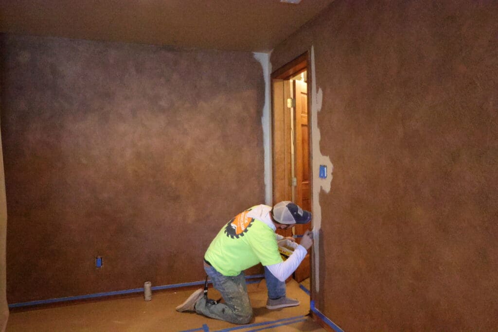 Black Mountain Painting technician taping and prepping a doorway before repainting an interior room in Spearfish, SD