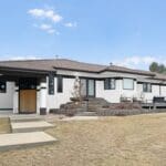 Repainted home in Rapid City SD with modern white and charcoal exterior by Black Mountain Painting.