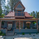 Freshly repainted historic home in Deadwood SD with new blue and red exterior completed by Black Mountain Painting.